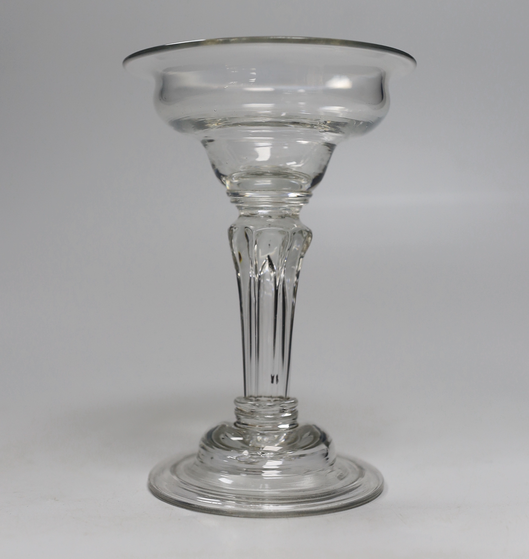 An English lead crystal champagne or sweetmeat glass, c.1745, flat double ogee bowl with everted rim, on double collar, eight sided Silesian stem on double collar, domed, folded foot, rough pontil, 15.6cm high